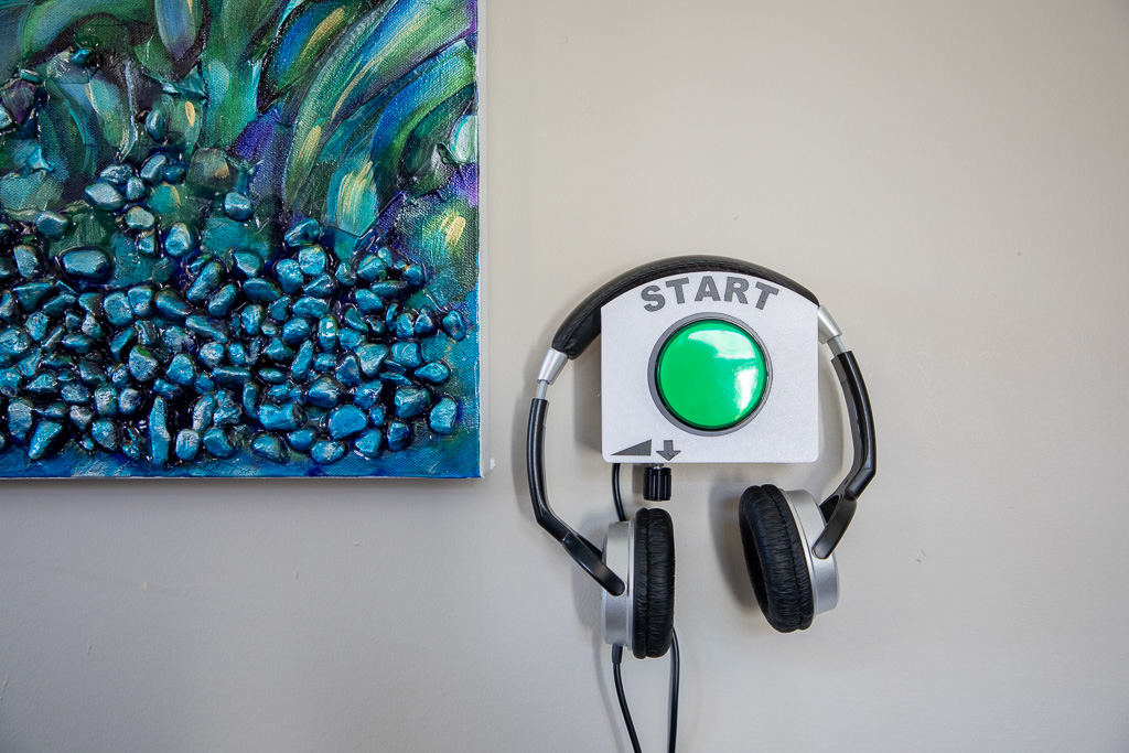 Headset used for audio descriptions beside a painting